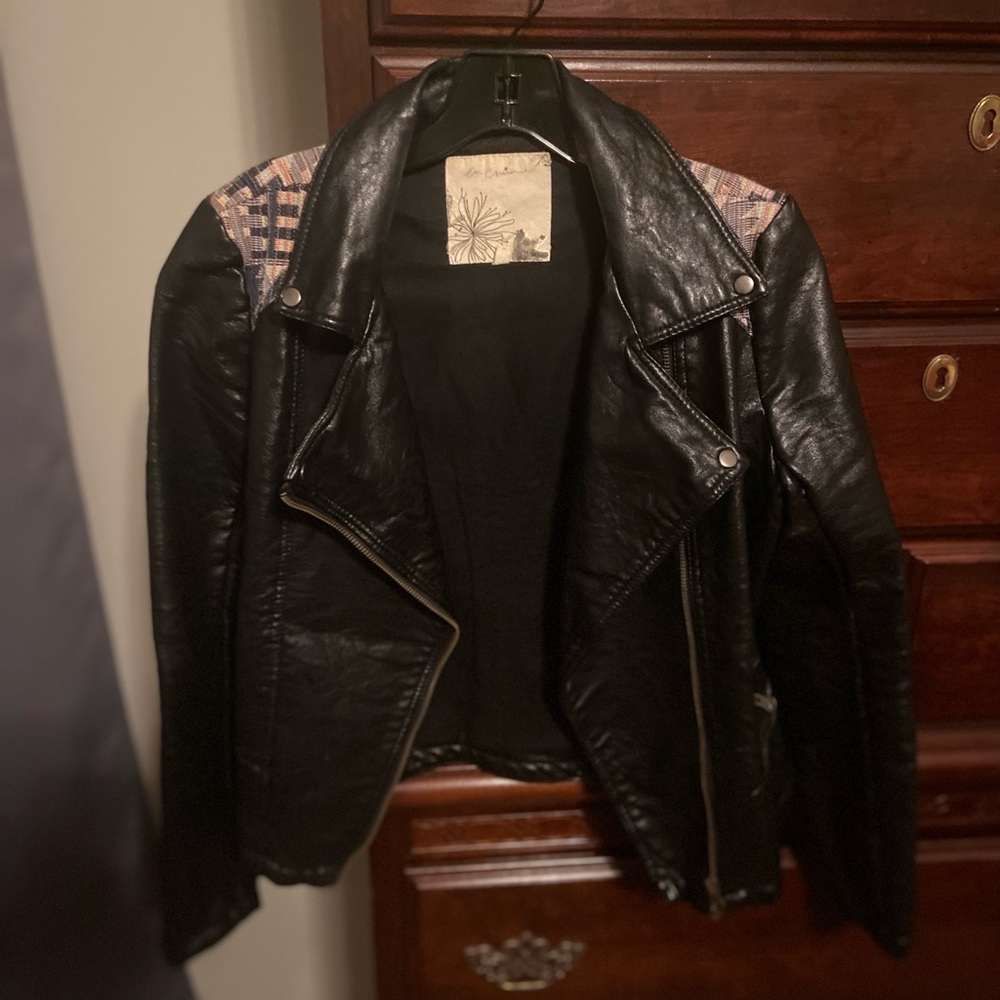 Like new, leather jacket with Navajo print detail.